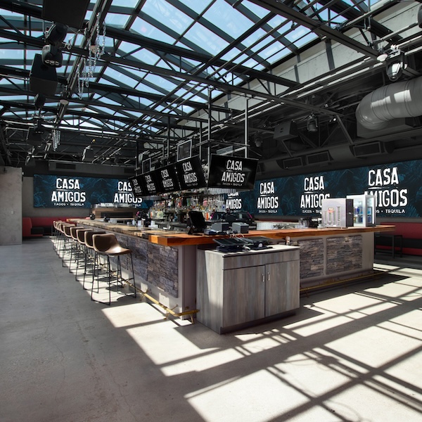 bar with modern decor, red and black cushioned booths