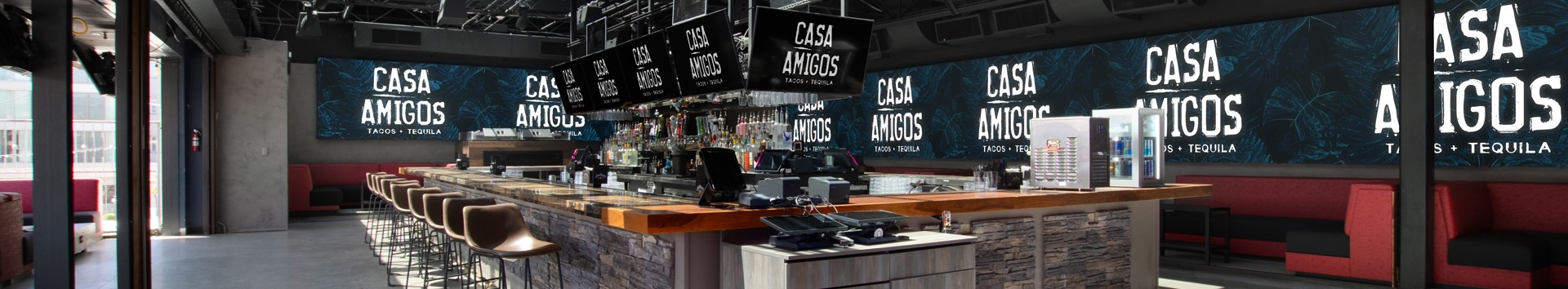 bar with modern decor, red and black cushioned booths