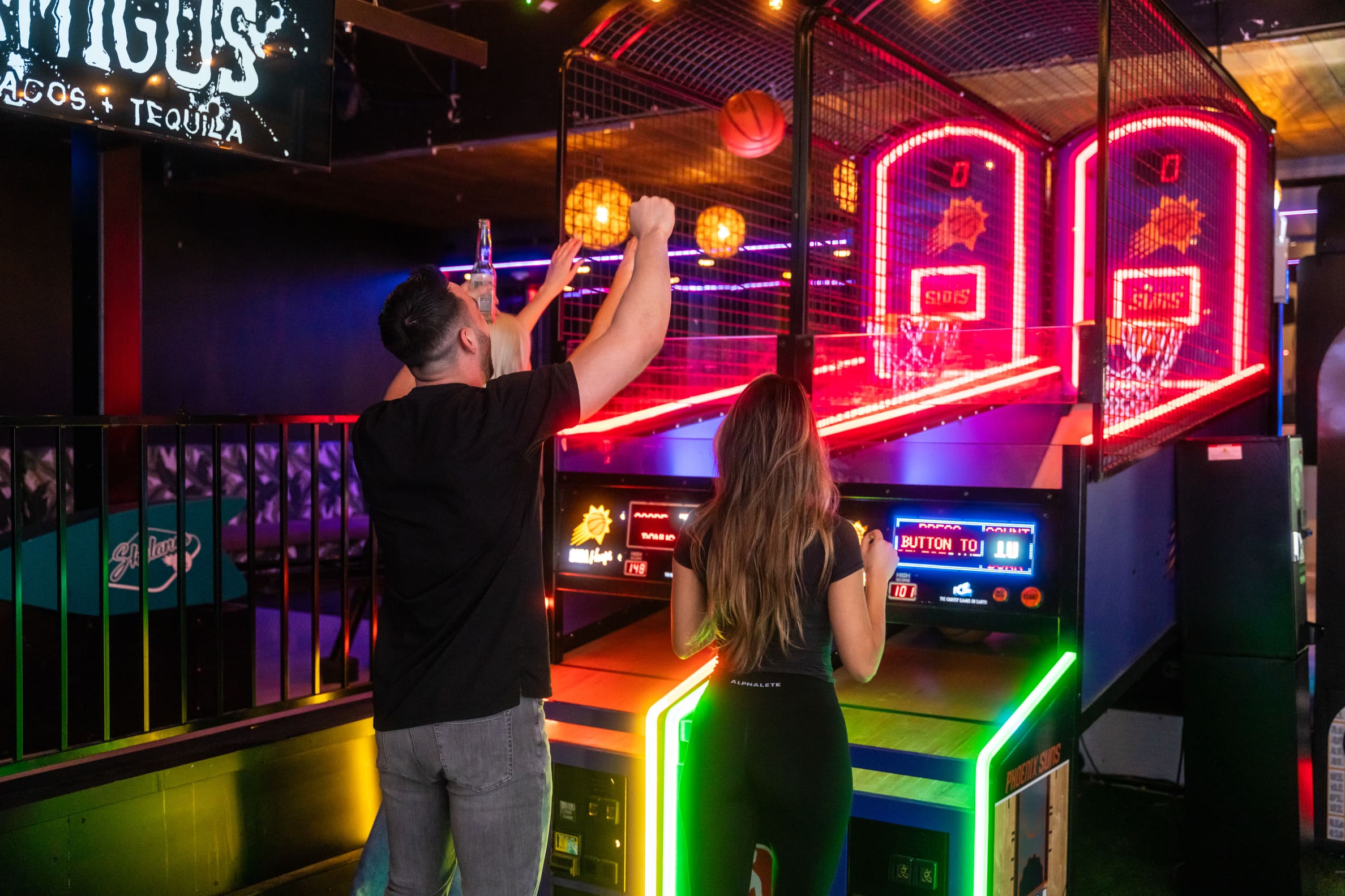 man throwing a basketball at the arcade in Casa Amigos